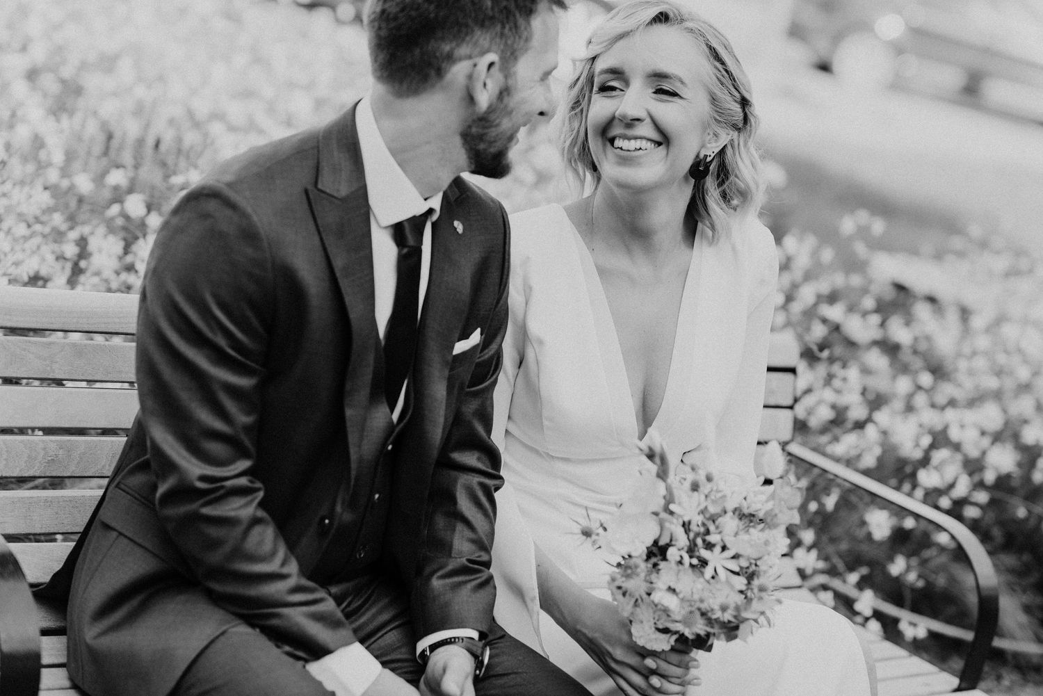 Black and white wedding portraits showcasing joyful intimate moments between newlyweds.