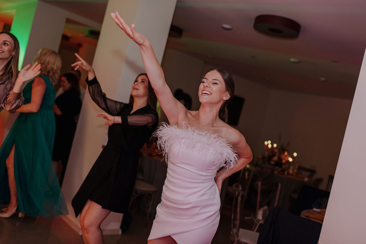 Wedding reception dance floor filled with joyful celebration and energetic movement.