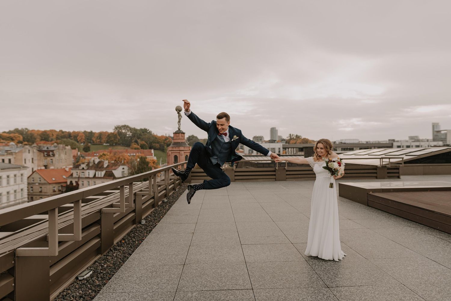 Couple shares romantic moment on urban rooftop with cityscape views.