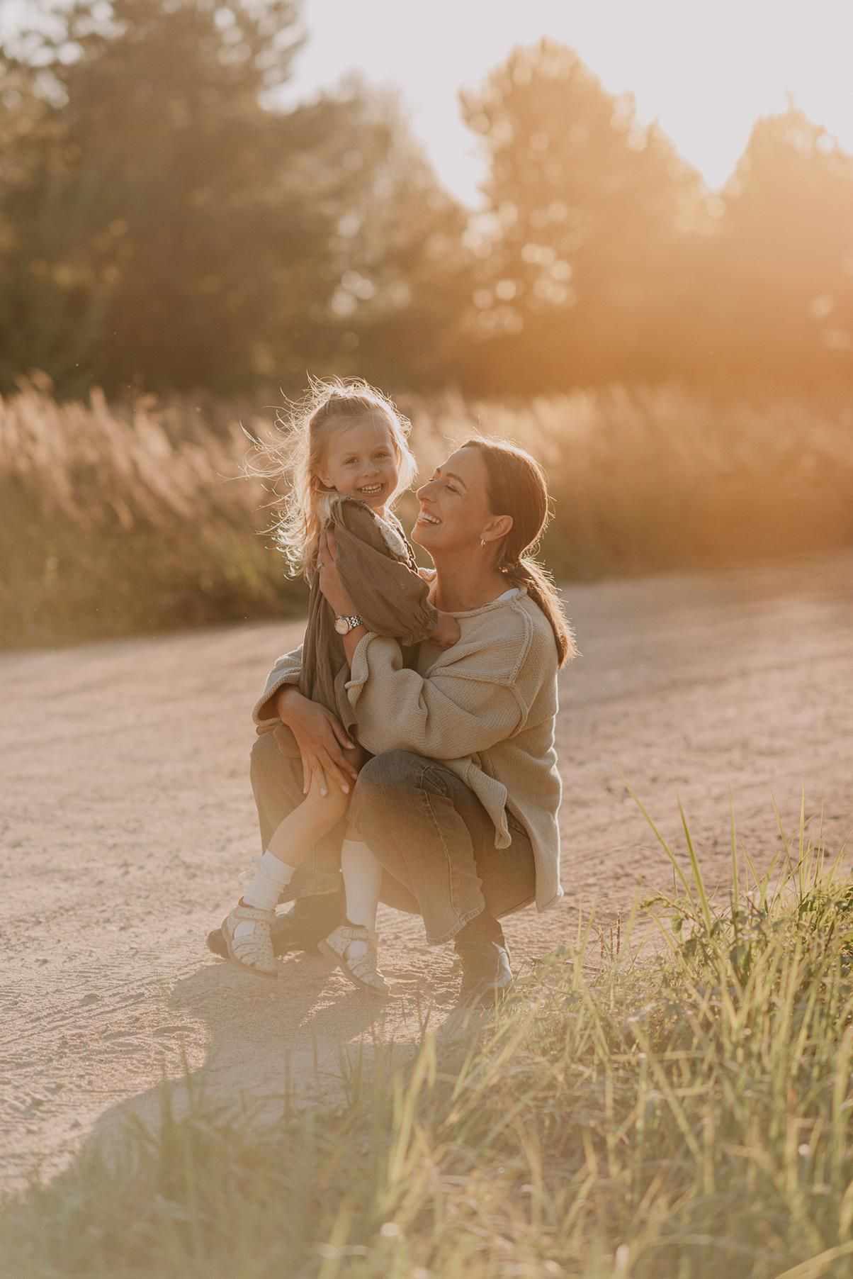 Playful family interaction captured in golden evening light.
