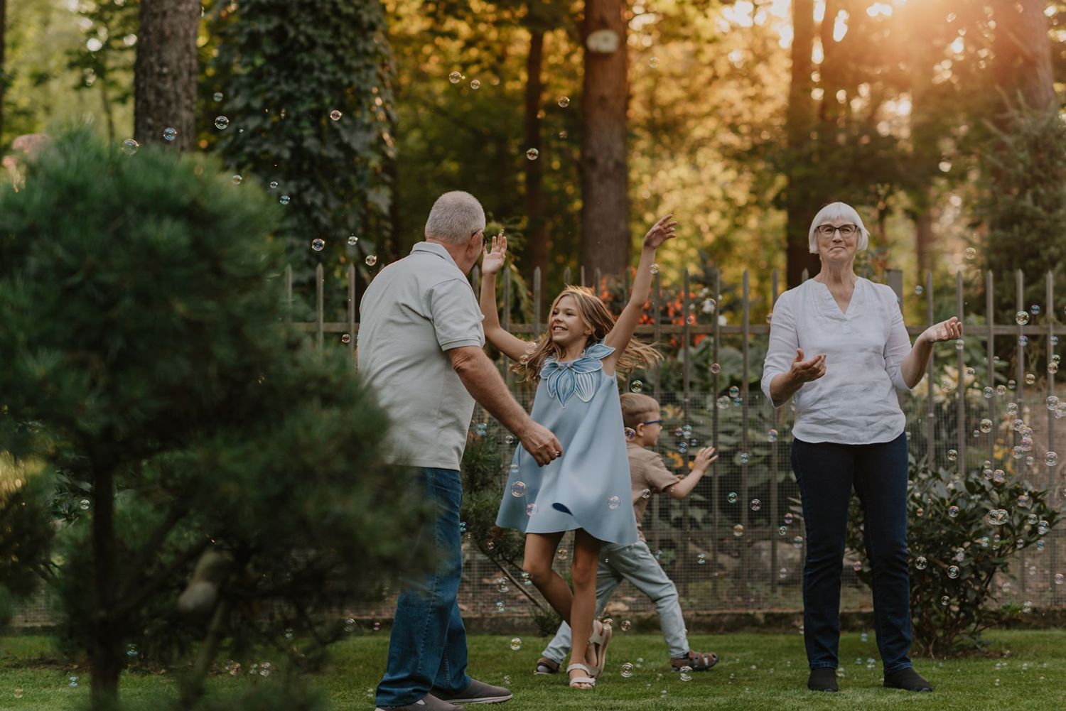 Playful family photography session in park during golden hour.