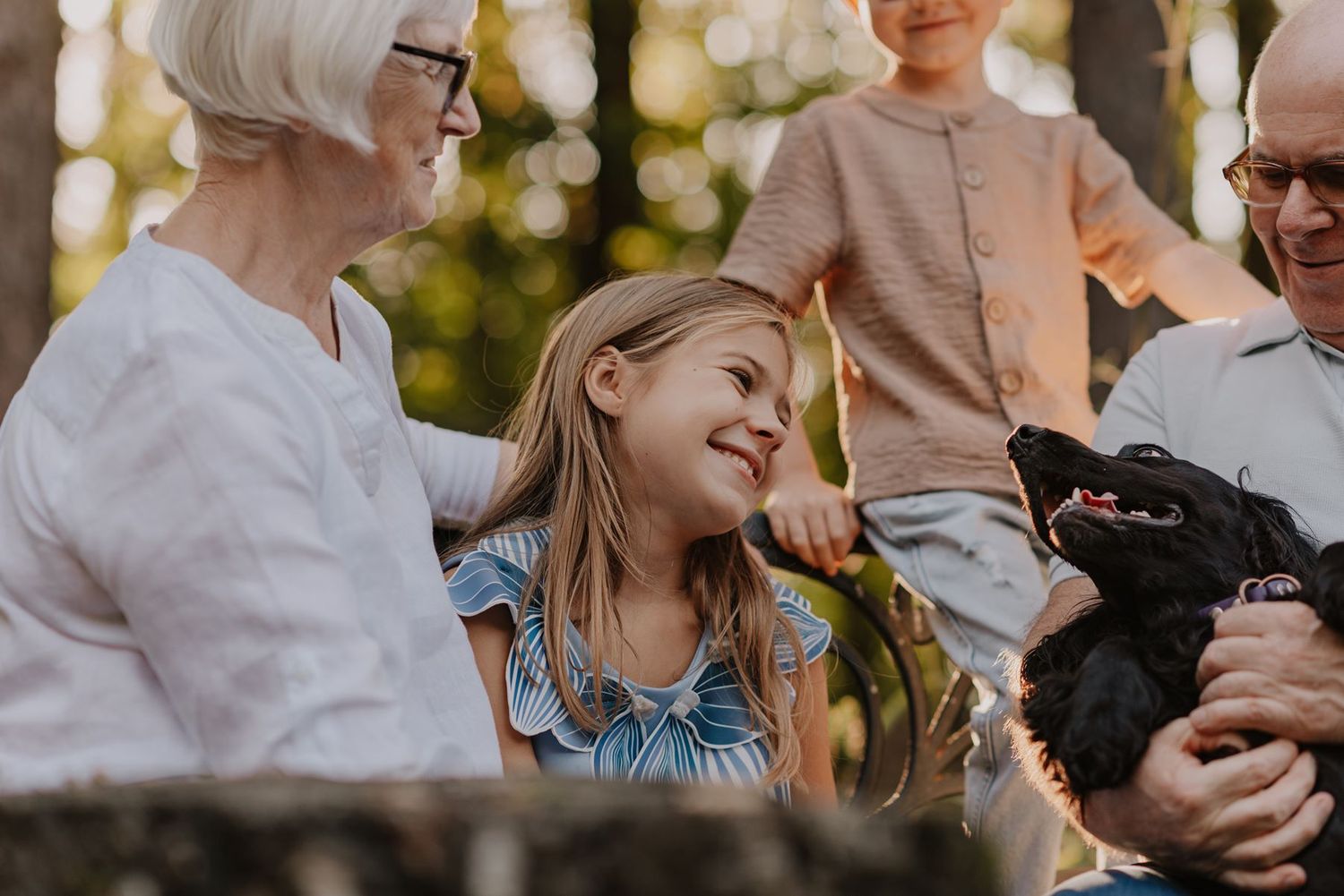 Casual outdoor family photo session with natural bokeh effects.