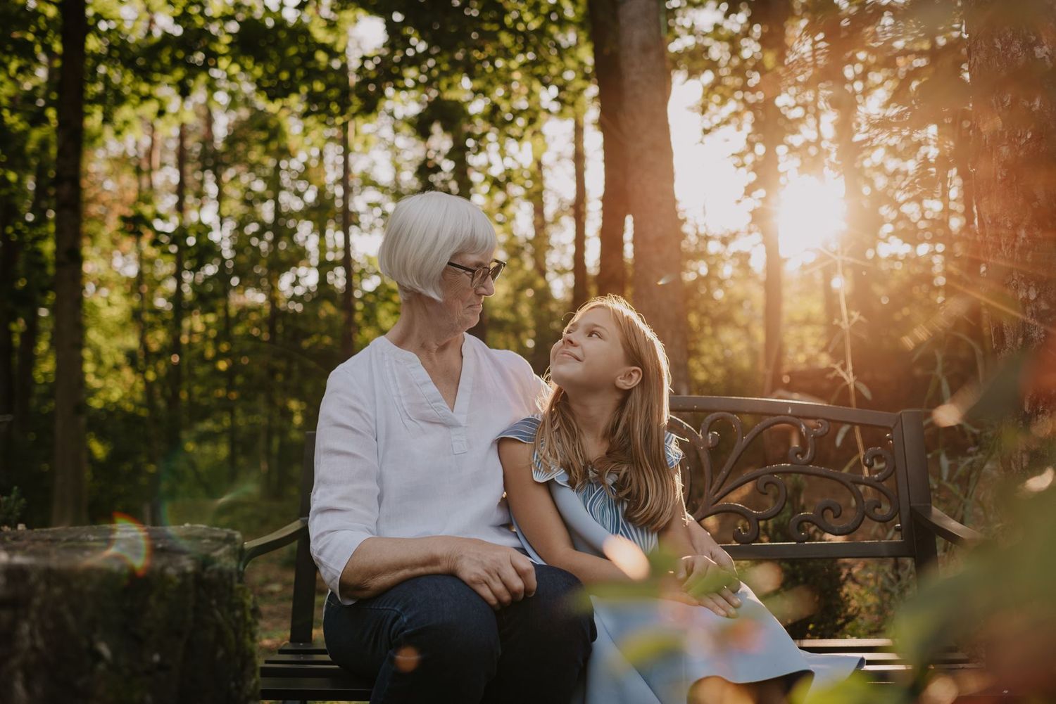 Intimate family moments shared on an outdoor bench during golden hour.