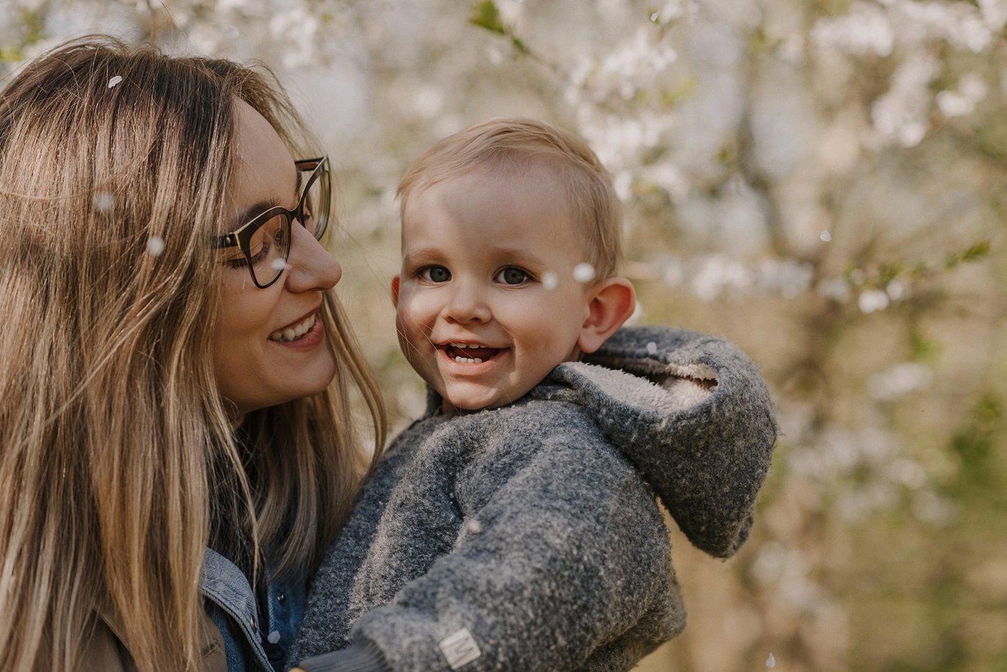 Sweet family interactions under flowering spring trees.