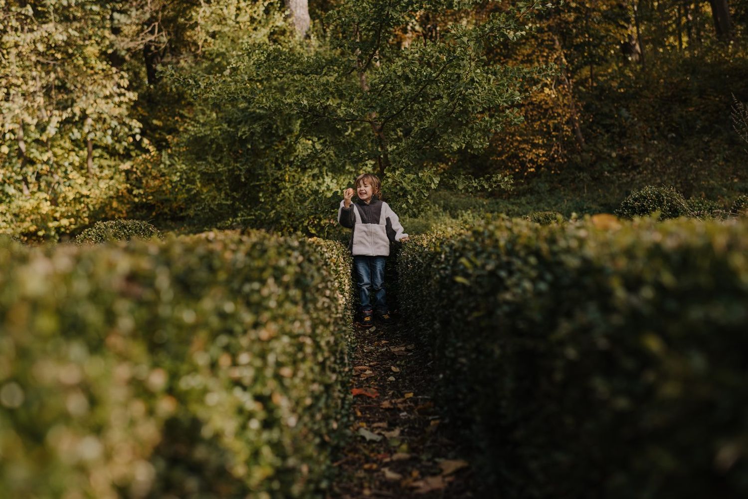 Golden fall foliage creates a magical backdrop for an outdoor photoshoot.