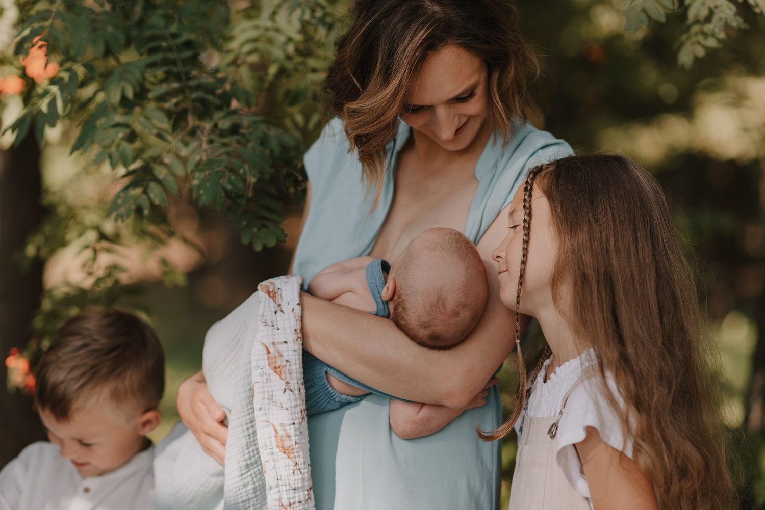 Sweet family moments captured outdoors against a backdrop of greenery and natural light.