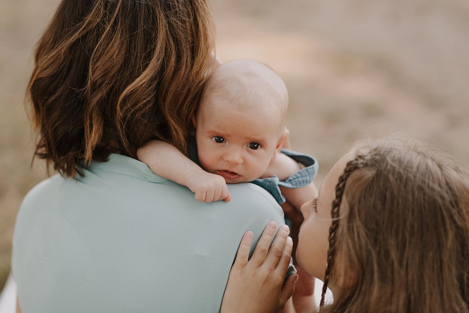 Intimate family photography session showing tender embraces outdoors.