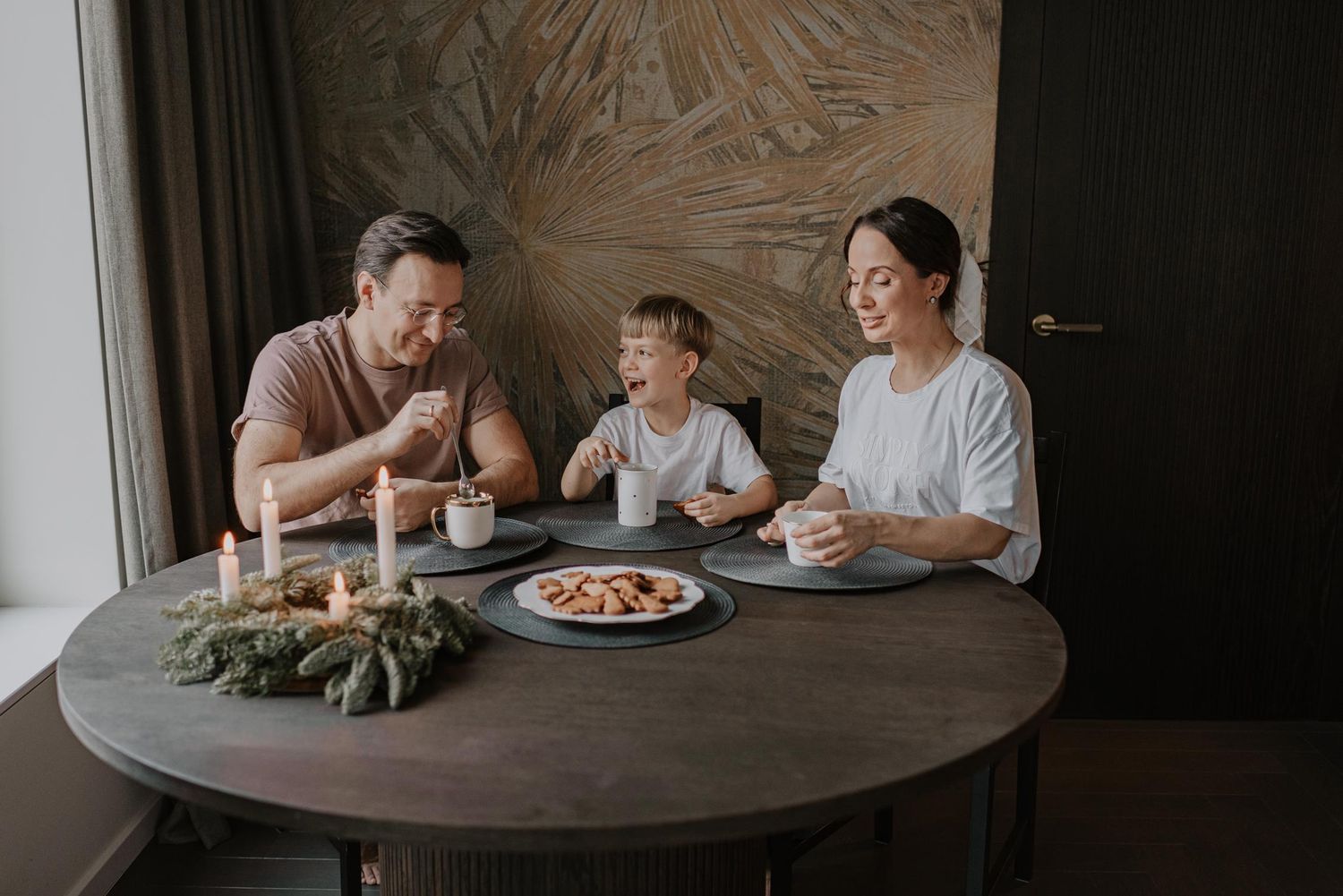 Family gathered around dining table for mealtime together.