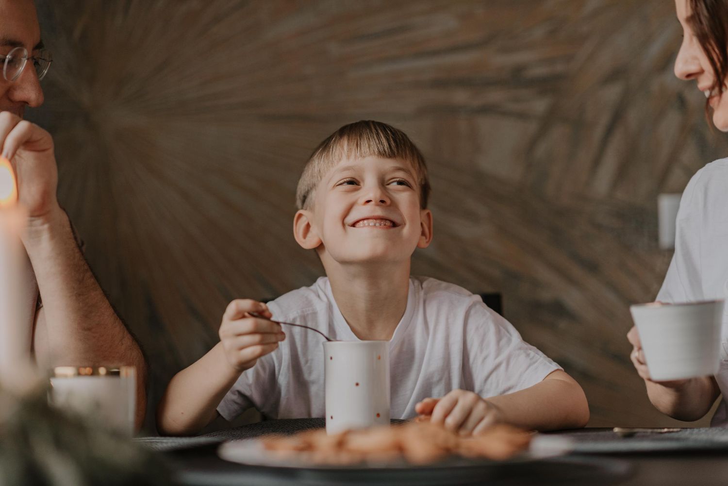 Happy moments shared around dining table with drinks and snacks.
