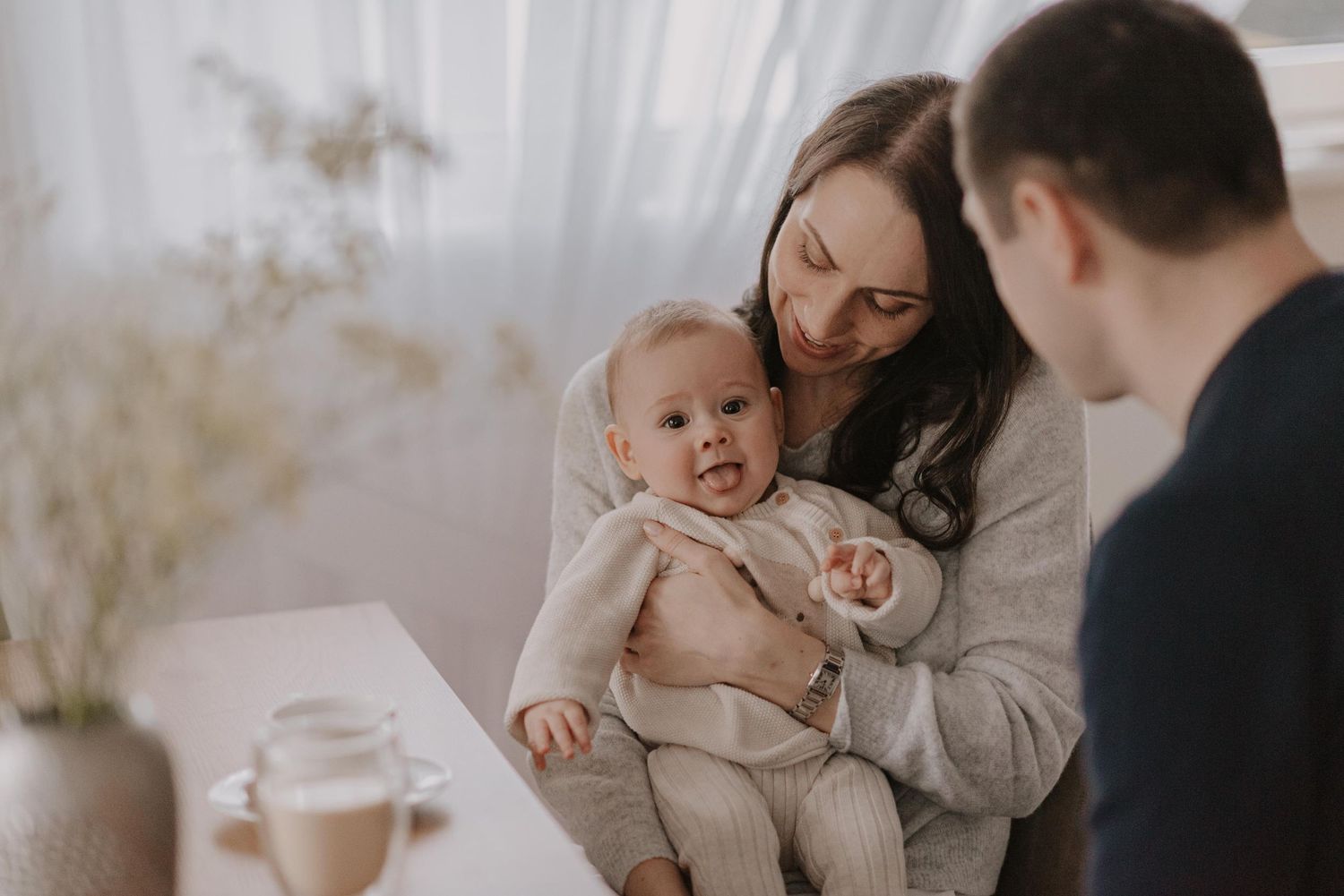 Tender family moment in modern home as mother and baby bond during mealtime.