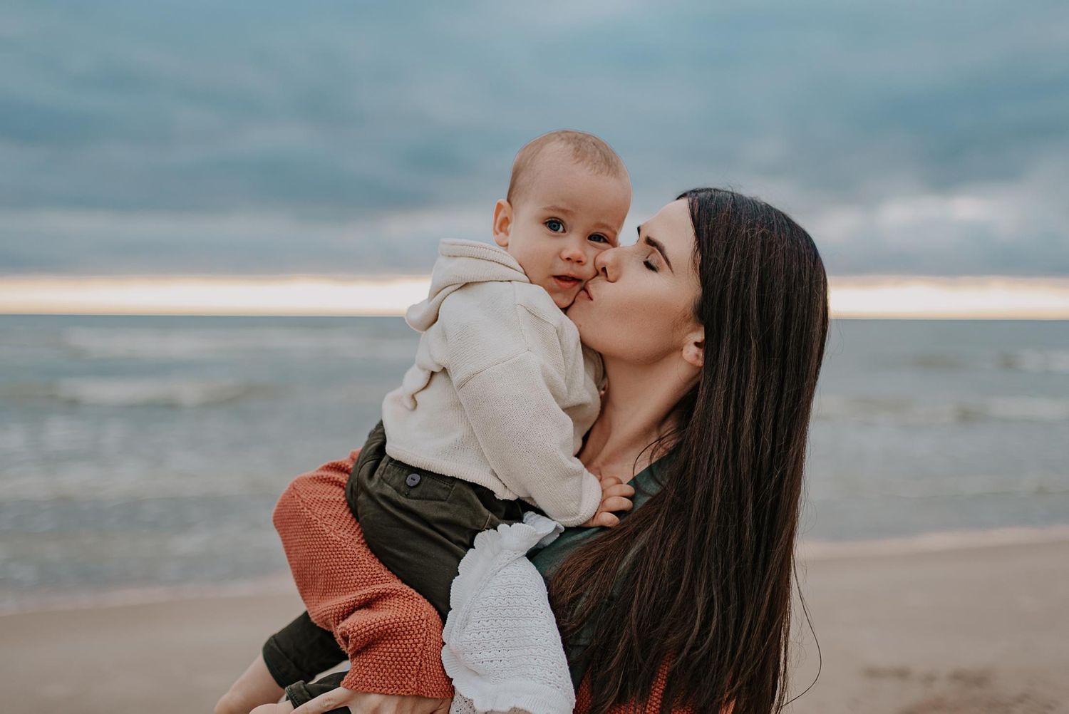 Sweet candid family interactions during beach sunset photography session.