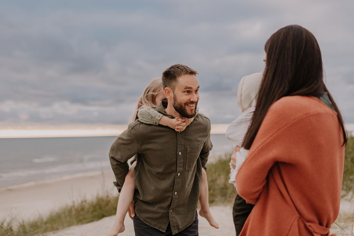 Casual candid moment of family enjoying time together at scenic coastal location.