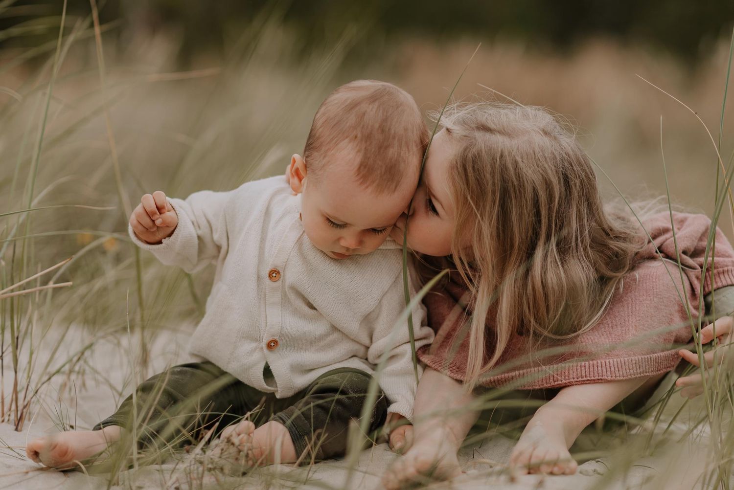Intimate family portrait captured while relaxing in beach grass.