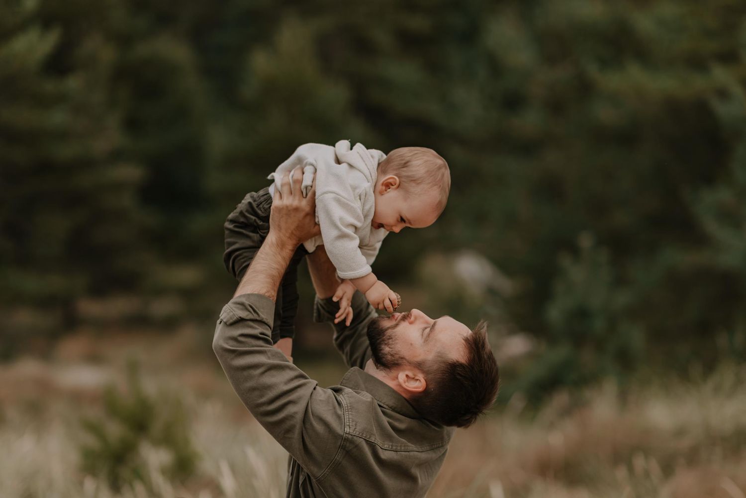 Playful candid moment during outdoor beach family photo shoot.