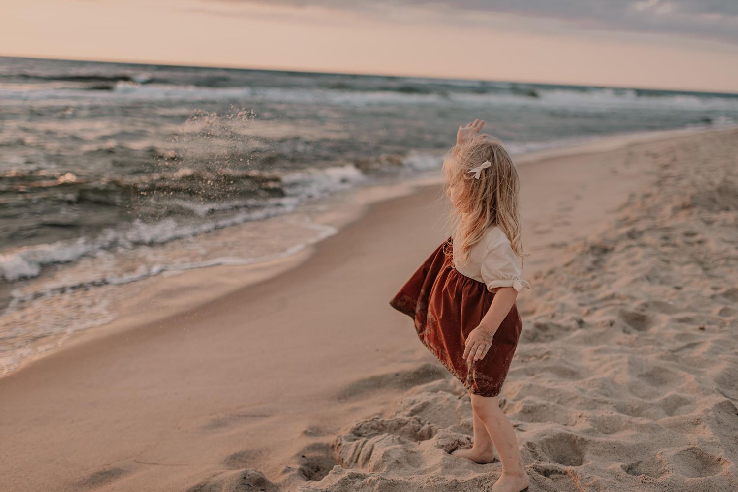 People enjoy a romantic moment on beach at dusk with gentle waves and warm lighting.