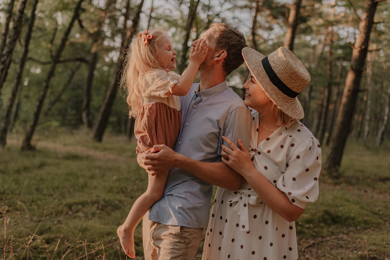 Intimate moment captured in pine forest during golden hour.