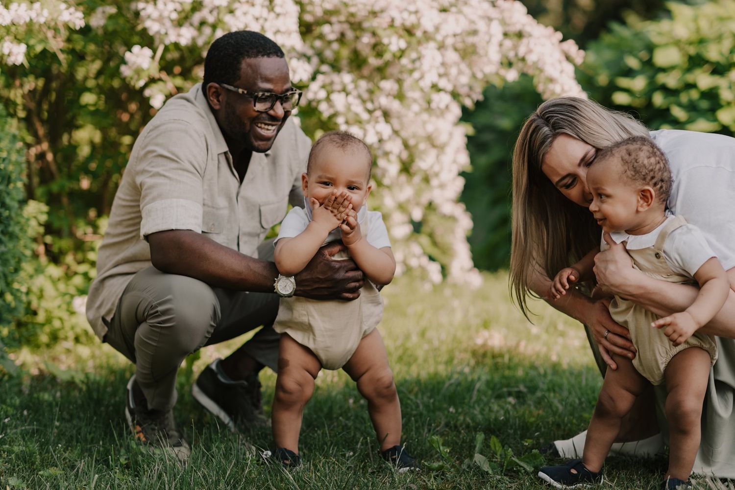 Sweet family interactions captured in a series of outdoor portraits under flowering trees.