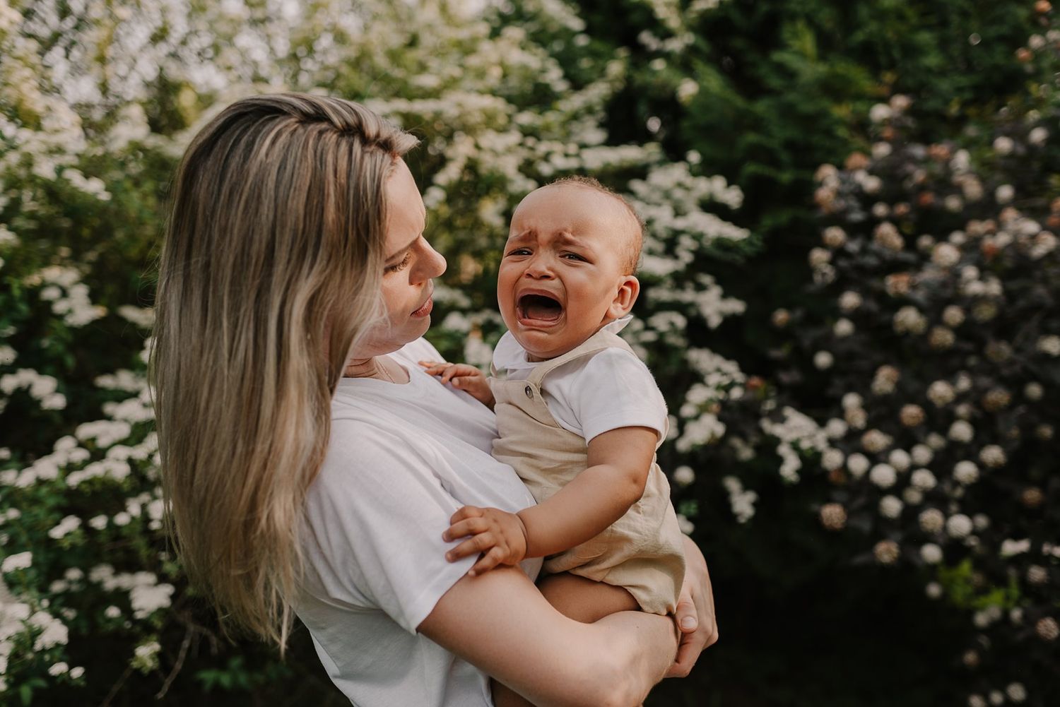 Beautiful family moments captured against blooming spring flowers.