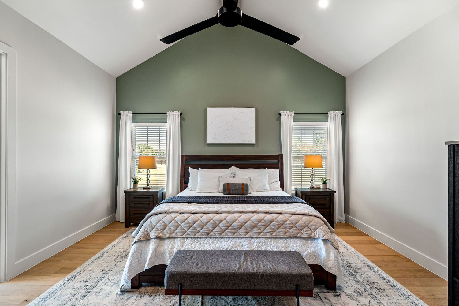 primary bedroom green wall luxury listing