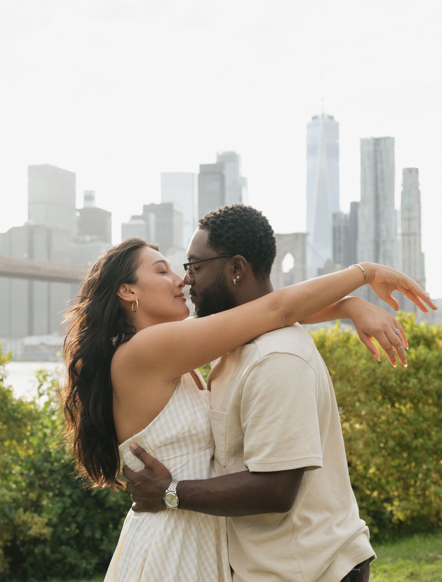 A romantic embrace with the New York City skyline in the background.