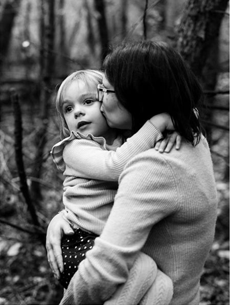 A touching black and white photo series shows tender embraces and hugs in a natural outdoor setting.