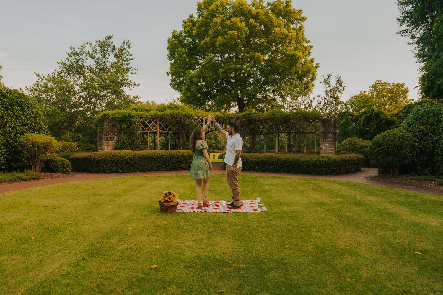 Panoramic view of a lush green lawn with trees and a small garden statue in a peaceful backyard setting.