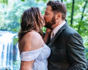 Intimate wedding moments captured against a backdrop of green forest and waterfalls.