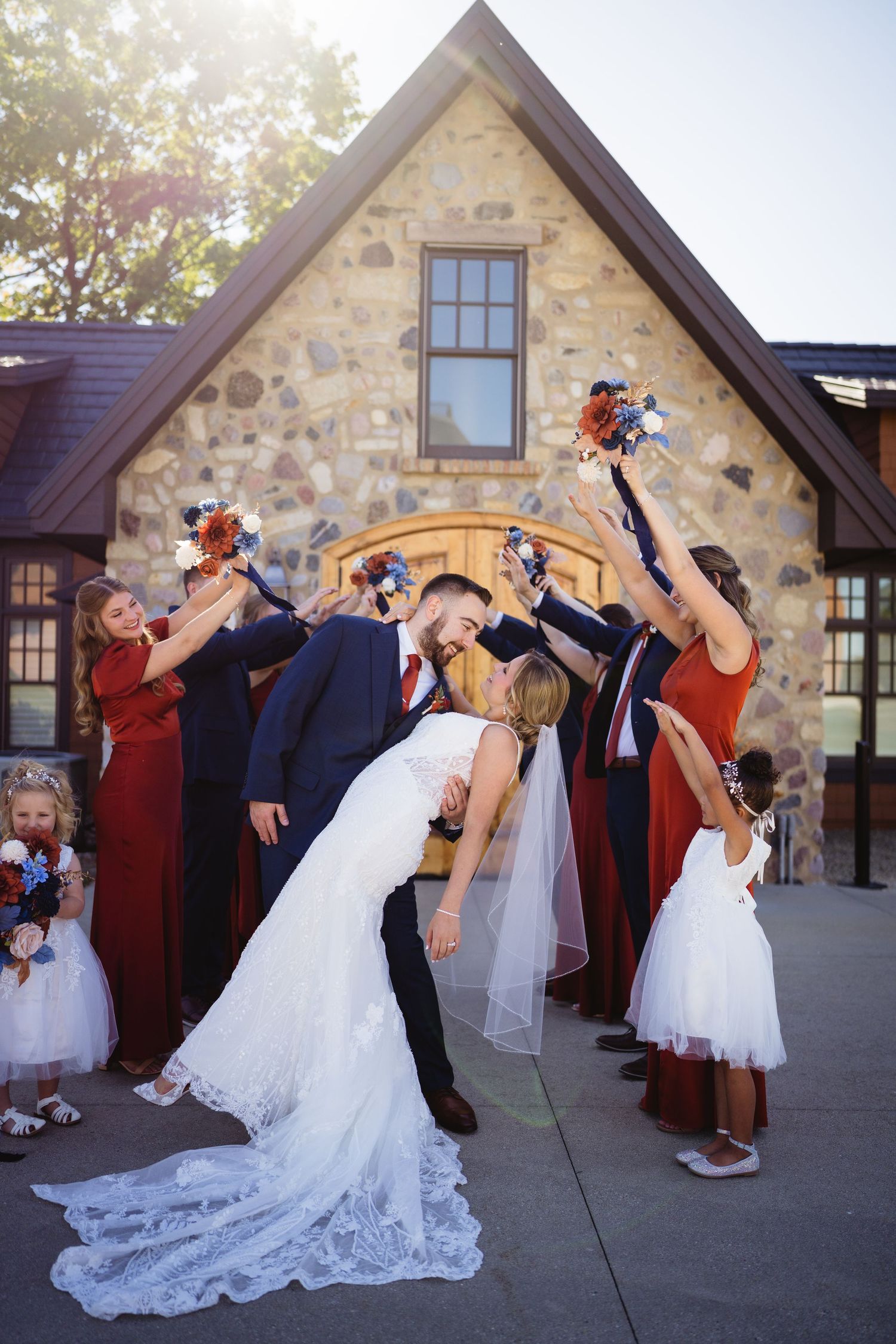 Wedding party performs synchronized dance moves outside stone building in sequence of celebratory photos.