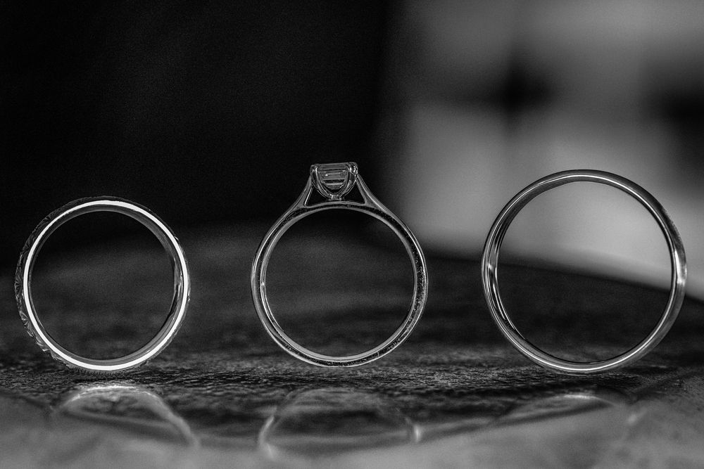 Wedding rings arranged artistically in black and white photography.
