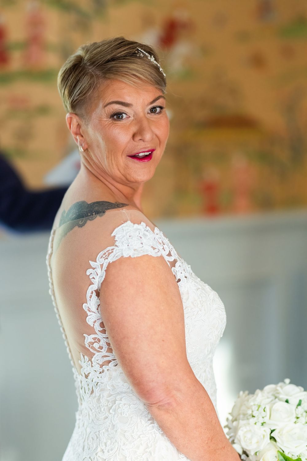 Elegant lace wedding dress detail with delicate floral patterns.