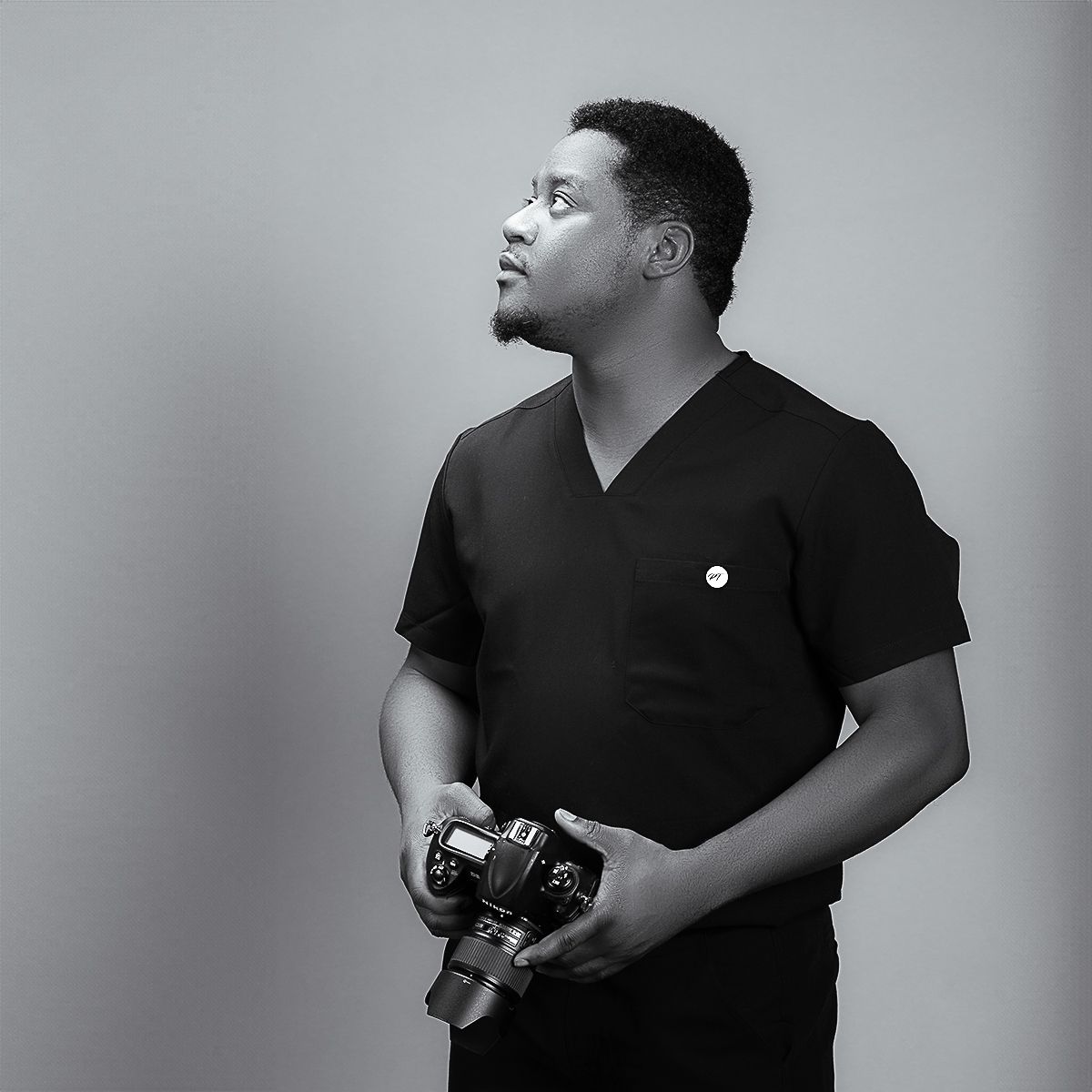 Black and white portrait series featuring photographer with camera.