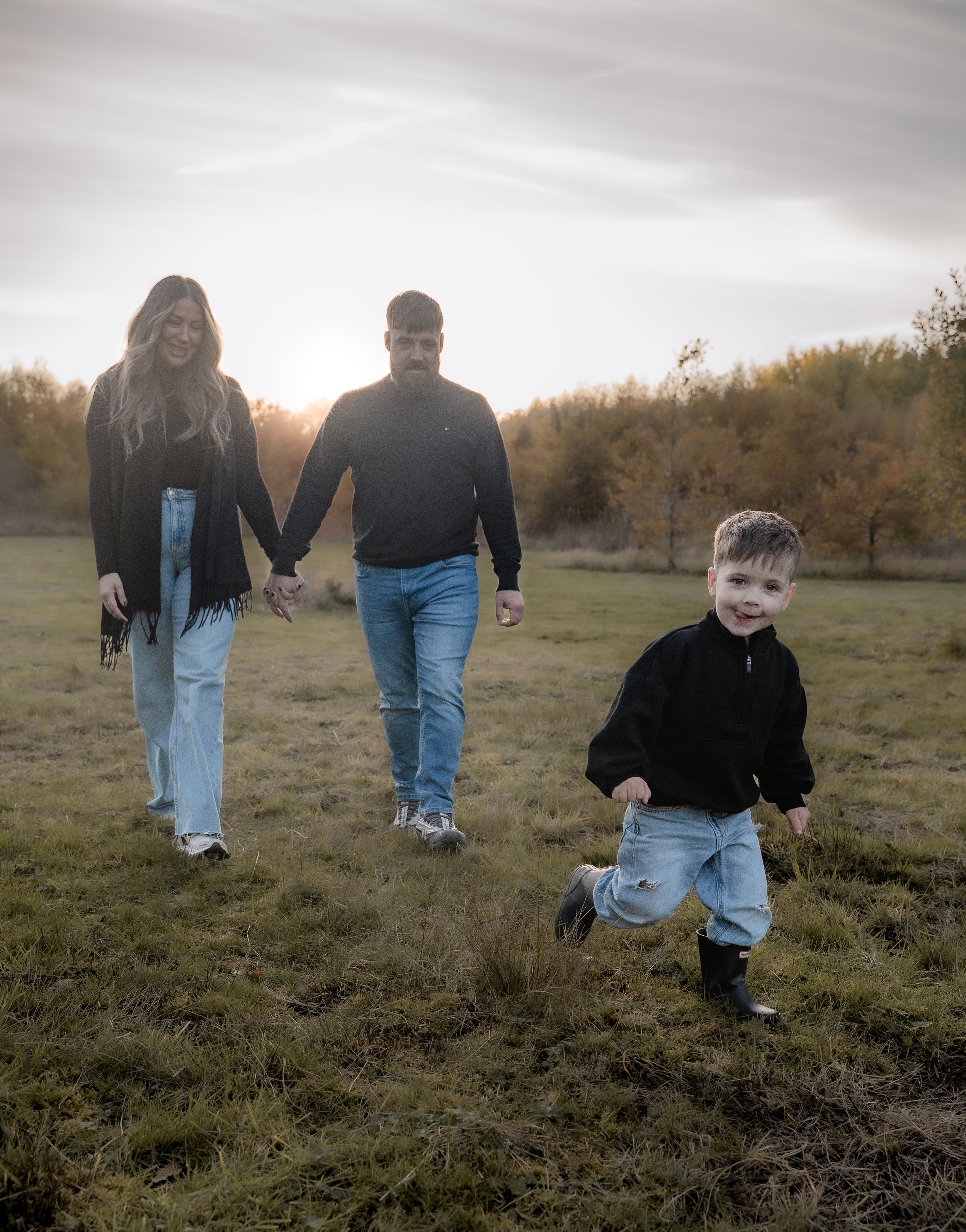 People walking together through a grassy field at sunset, captured in a series of candid moments.