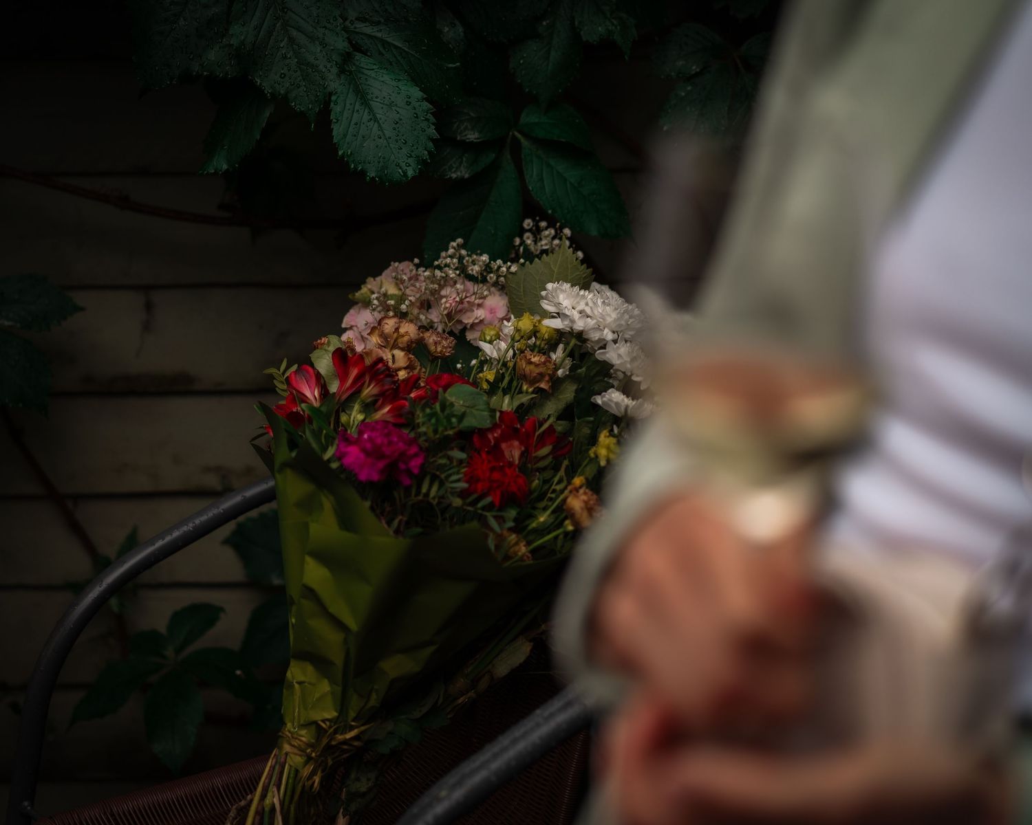 Blurred floral bouquet with dark moody lighting.