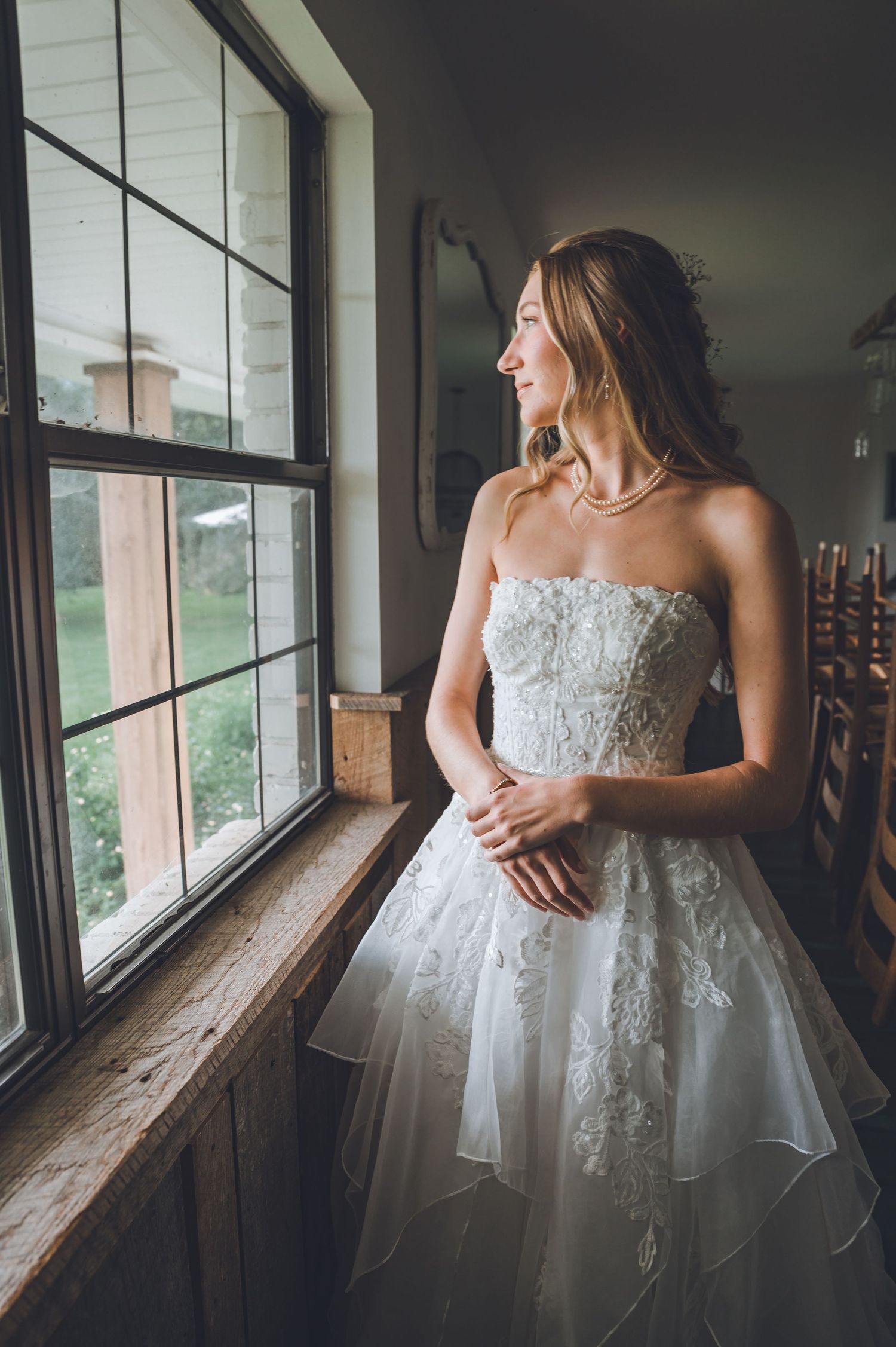 A series of romantic bridal portraits showing a white lace wedding gown against a rustic window backdrop.