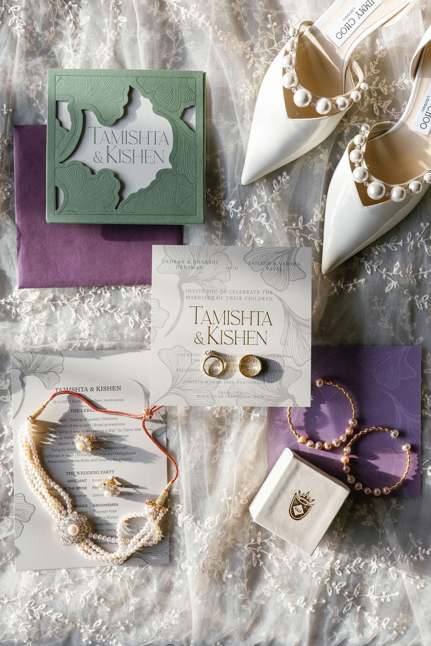 Elegant wedding flat lay featuring stationery, rings, and bridal shoes arranged on a textured backdrop