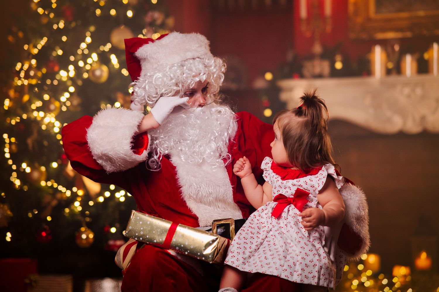 A festive holiday scene with a decorated Christmas tree, glowing lights, and traditional holiday figures in red and white attire.