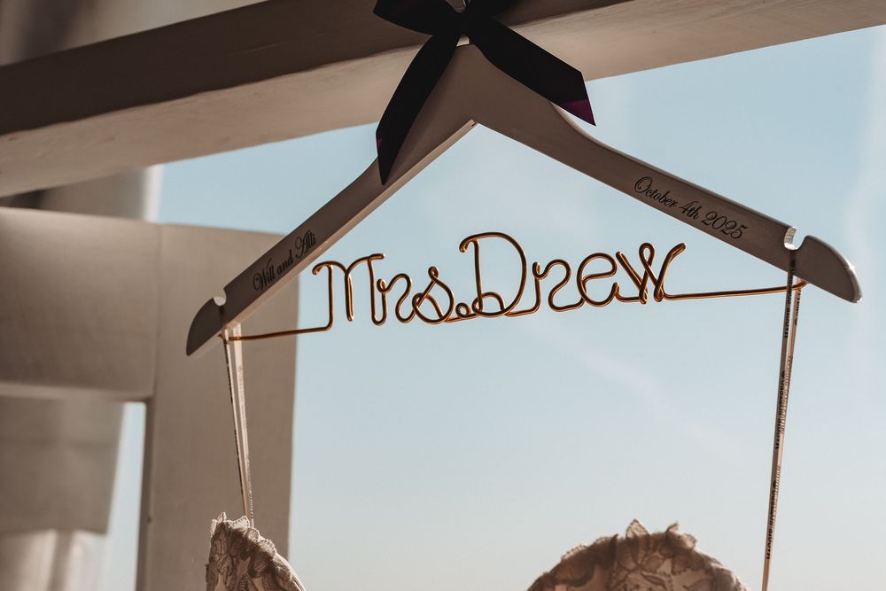 Custom wedding dress hanger displayed against light background.