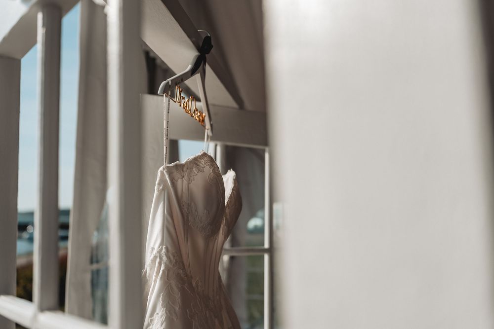 Elegant wedding dresses hang on display in a bridal boutique.