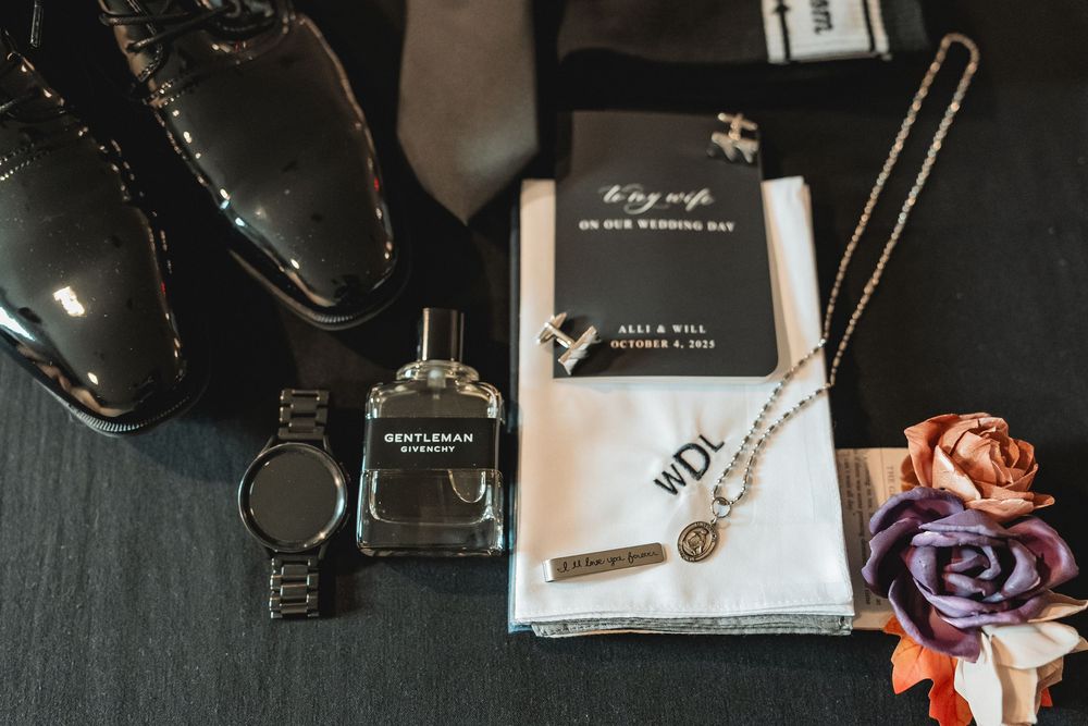 Wedding detail shot of jewelry and accessories on dark background.