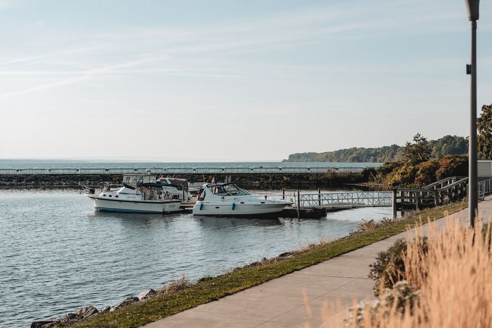 Scenic waterfront view with boats docked along a peaceful coastal shoreline.