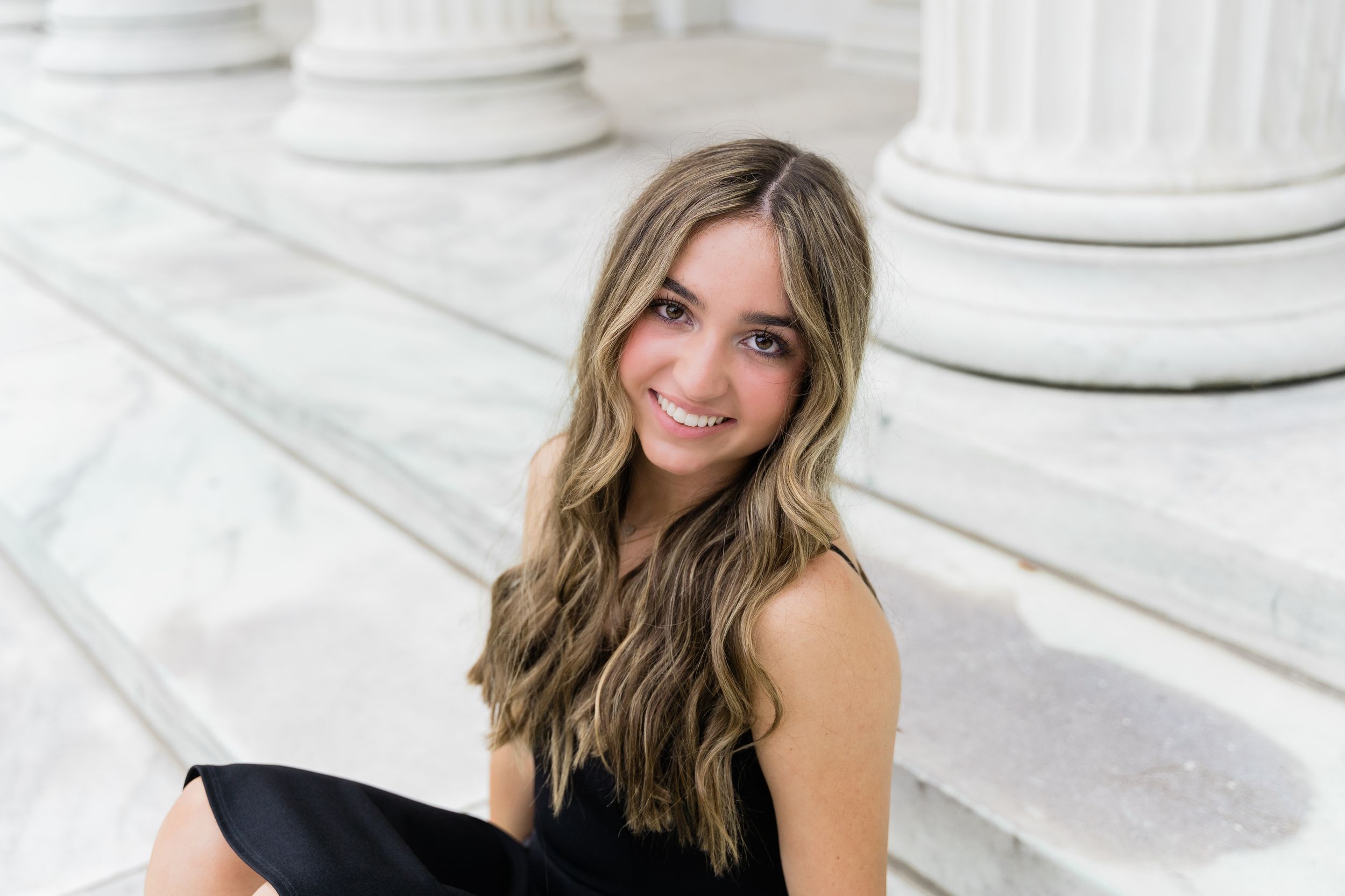 Series of headshots against white columns showing joyful expressions and casual black top.