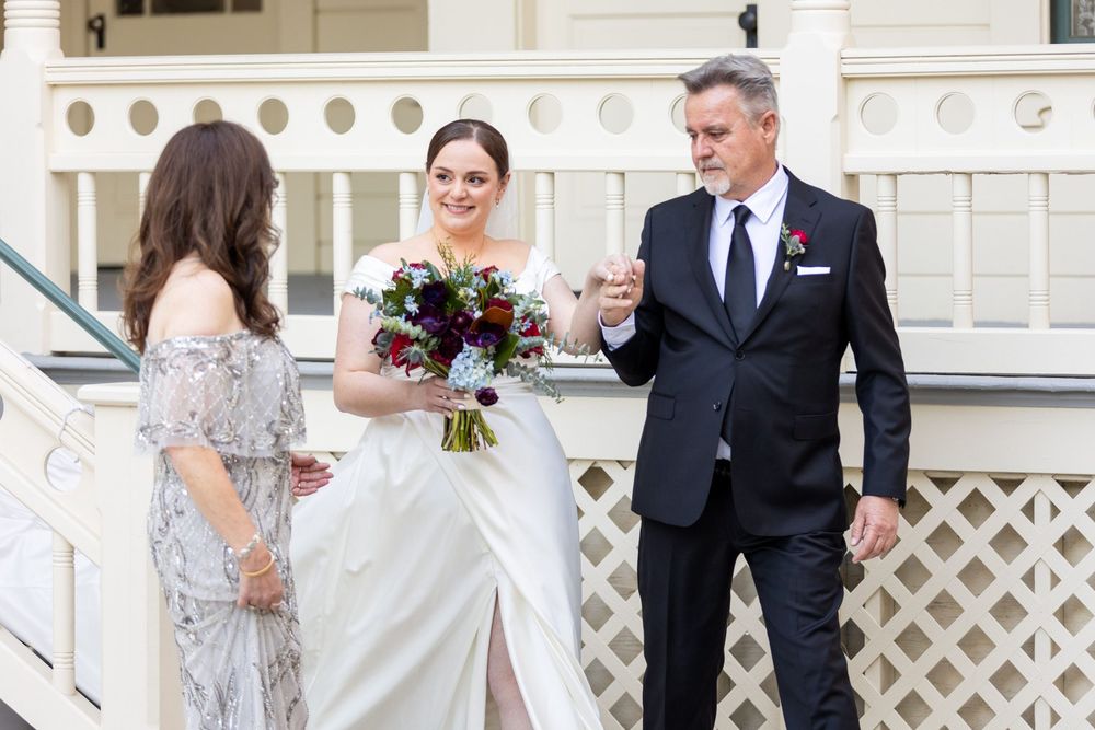 A black and white wedding photo collage showing tender moments between the couple and guests at an elegant venue.