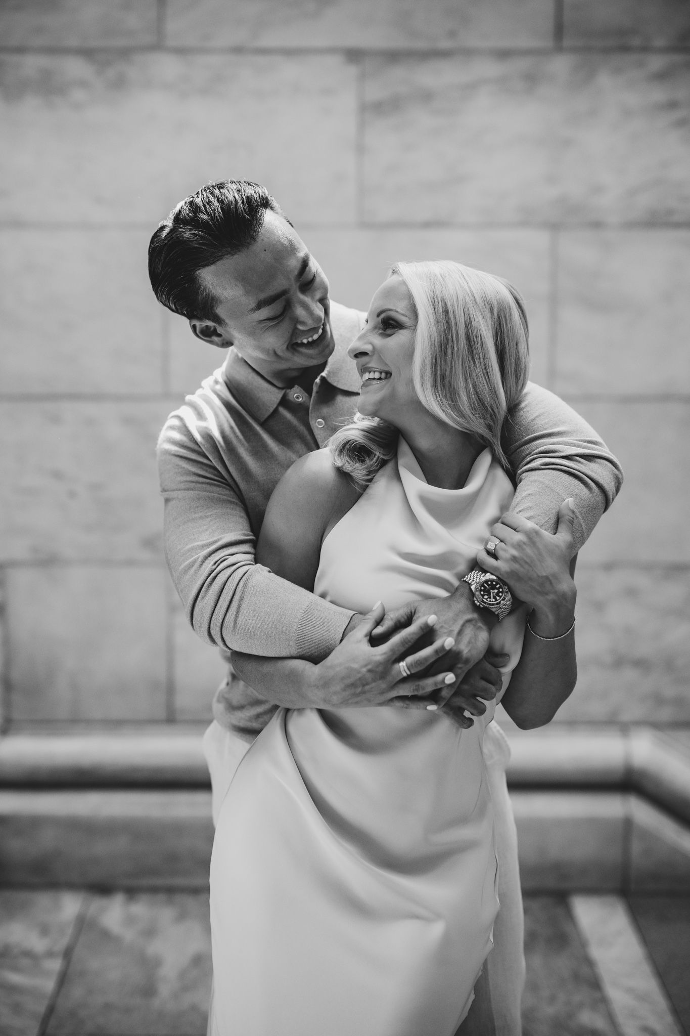 Playful engagement portrait session with couple in casual attire.
