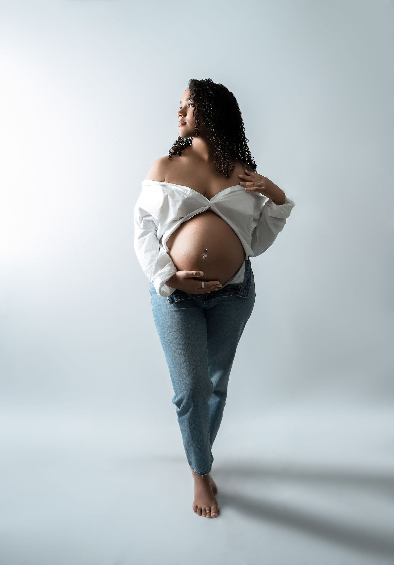 A series of artistic photos showing a person in blue jeans and white top posing against a light gray background.