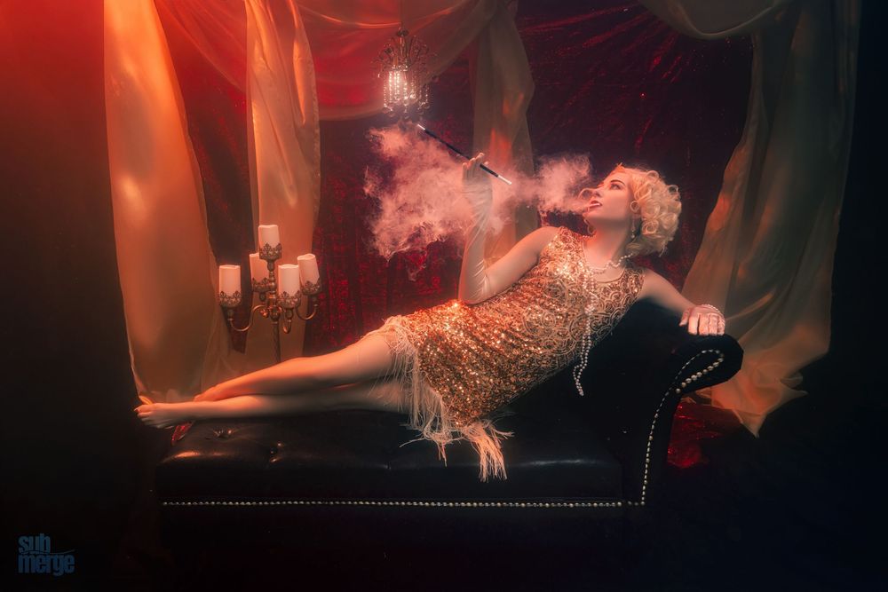 Dramatic underwater scene with orange and red lighting creating moody atmosphere.