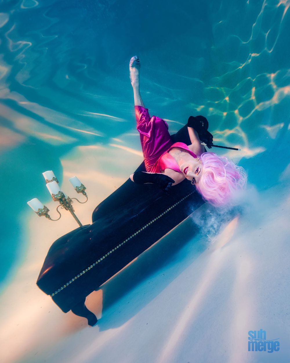 Ethereal underwater scene with flowing fabric in turquoise water creating graceful rippling patterns against sunlight.