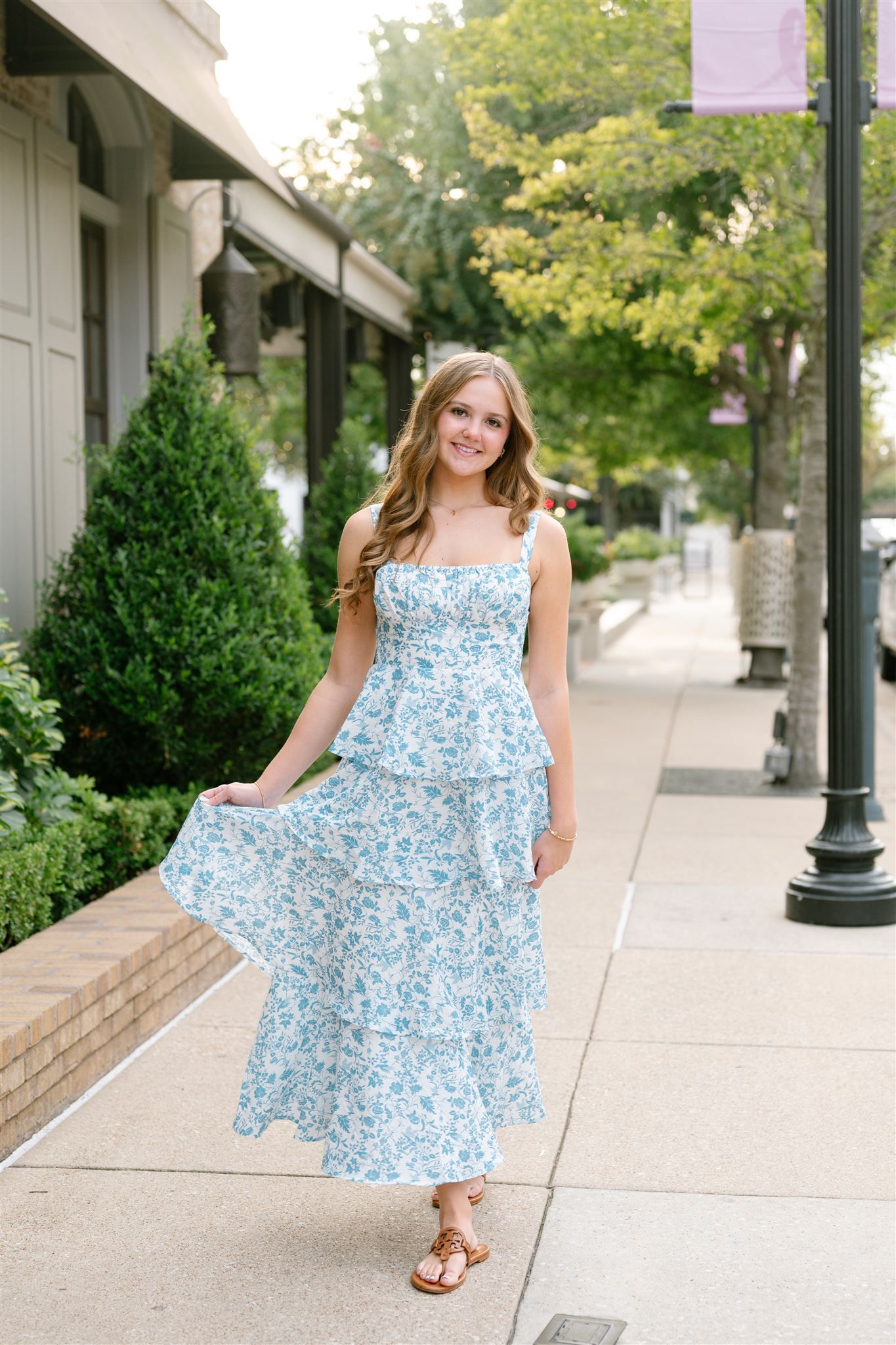 College Park High School girl posing for senior portraits in Market Street of The Woodlands, Texas