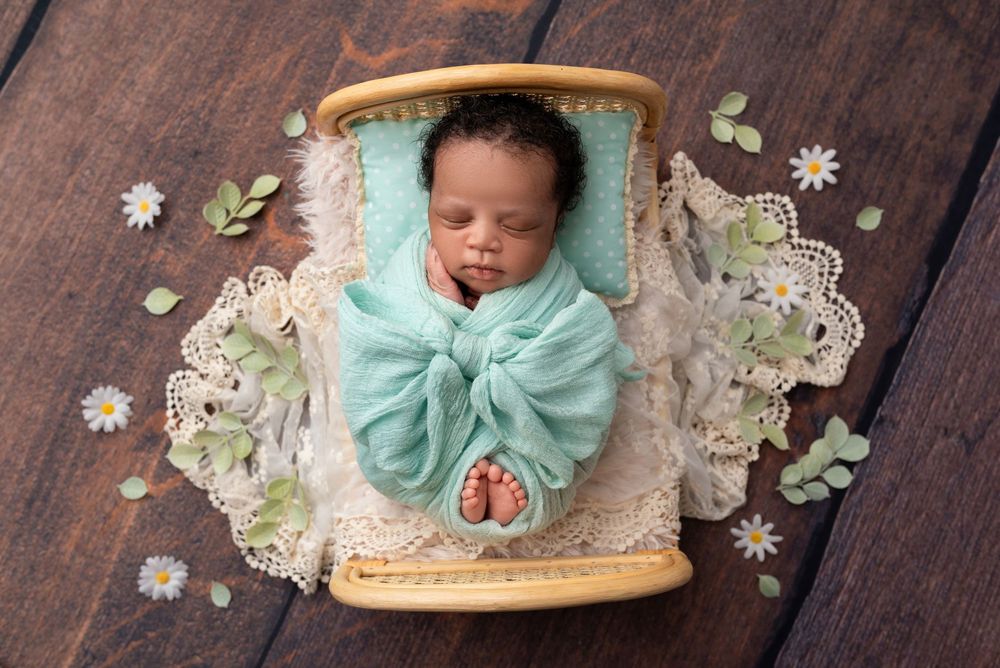 Newborn baby wrapped in soft blanket, sleeping peacefully in Wolverhampton studio