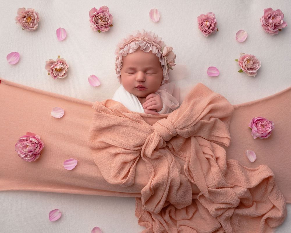 Newborn baby wrapped in soft blanket, sleeping peacefully in Wolverhampton studio