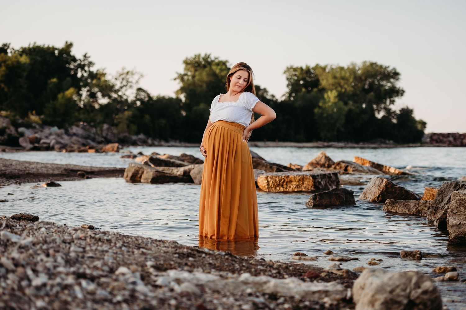 Maternity photo in green dress at sunset